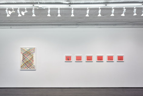 Gallery view of small red abstract works and larger painting