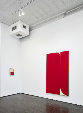 Gallery installation view of red abstract paintings