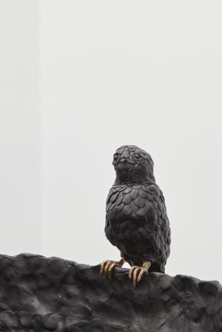 Sculptural bird sitting on nest