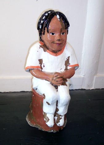 small ceramic piece of man sitting