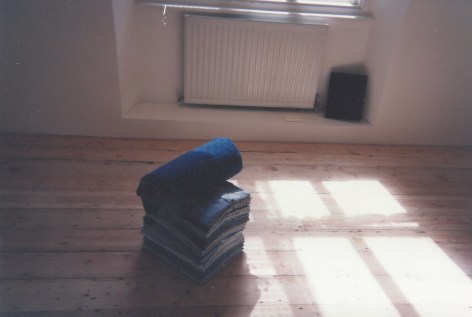 folded work shirts on gallery floor