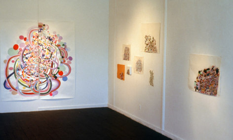 Installation view of abstracts of various sizes and colors