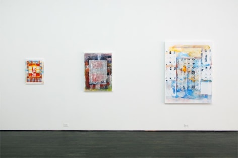 Installation view of three multicolored abstract pieces