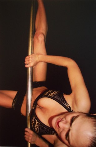 Still of dancer mounting pole