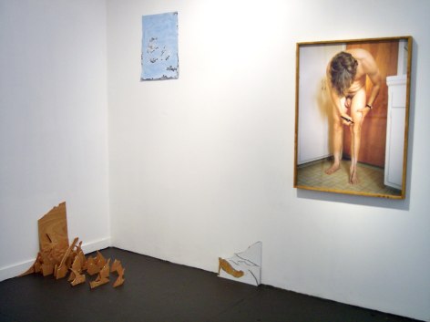 Photo of nude man, with wooden blocks on gallery floor