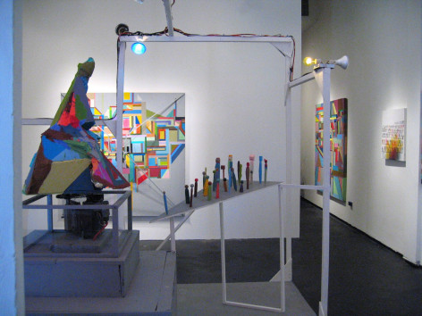 Installation view, small figures on wooden table