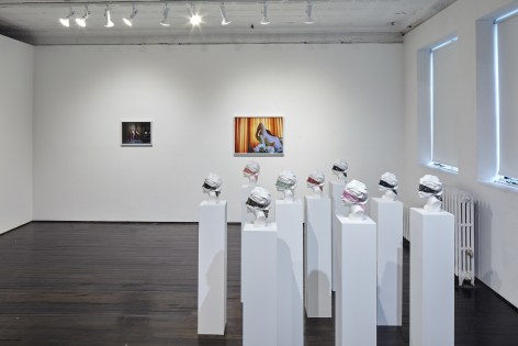 Gallery view of ceramic busts and photographs