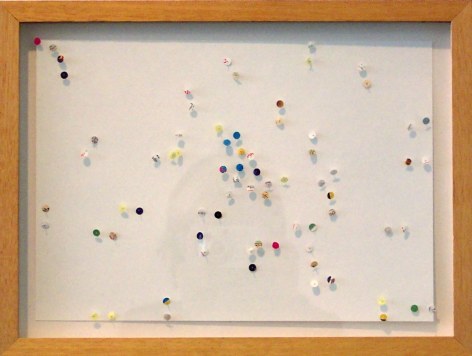 Colored thumbtacks on paper