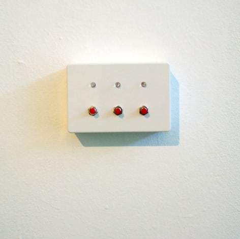 Metal encasing with three red buttons