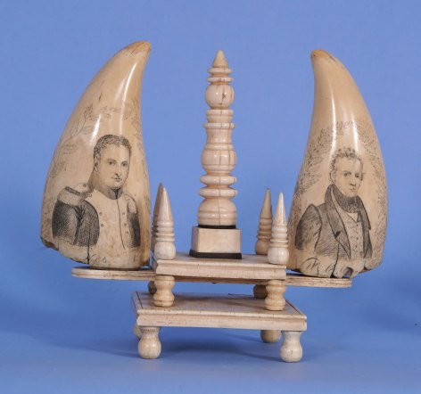 PAIR OF SCRIMSHAW WHALE'S TEETH WITH WALRUS IVORY AND WHALEBONE STAND