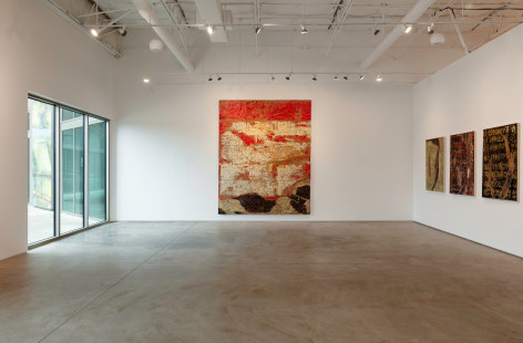 Installation view of one large Edgar Ramirez painting and three smaller (Smoke) Remnant paintings in various colors