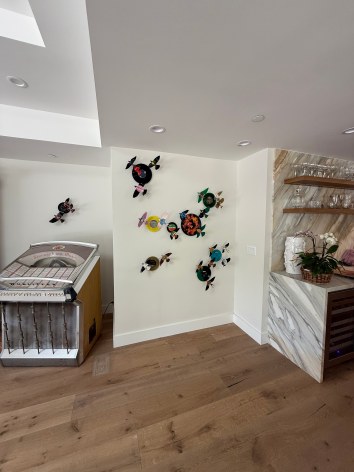 Like the site-specific, recycled aluminum can butterflies, Paul Villinski's LP Vinyl Record Bird Series is also available by commission. Making this work even more bespoke, even profoundly personal, the client chooses the individual records they would like to use as the material for sculptures. Selecting from one's own favorite singers, musicians, and albums, the resulting installation tells the story of the music which inspires the client musically . . . but now also visually.,  