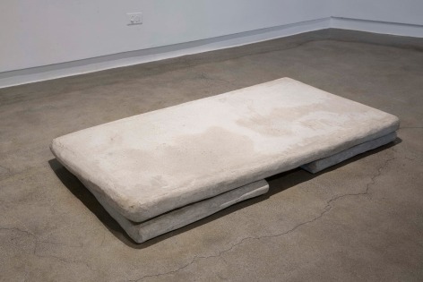 Two slabs of concrete and one larger one resting on top to make a rectangle
