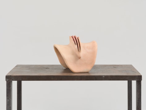 Pink abstract sculpture sitting on table