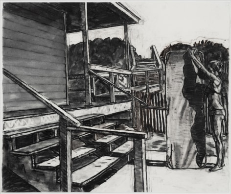 The view is the side of a house. One can see a short set of stairs and in the background there is a woman holding a beach board vertically as she makes adjustments to it.