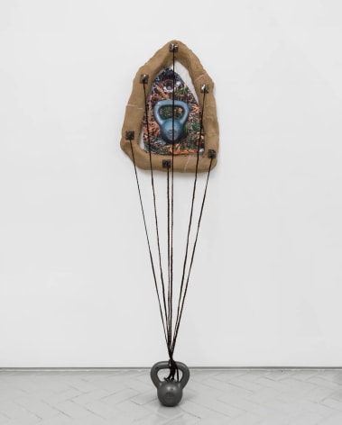 Manal Kara  The Image, 2022  ceramic, photographic prints on fabric, kettlebell, synthetic hair  27.5 x 22 x 4 in with 8 x 8 x 5 in object on floor attached to wall piece by hair