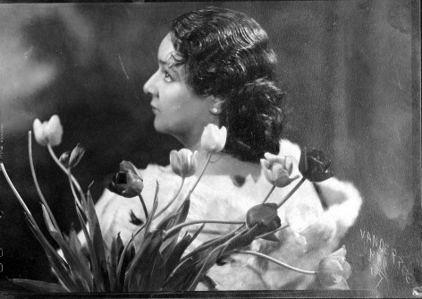 Untitled (Portrait of woman posing with flowers), 1937  Vintage gelatin silver print  4 5/8 x 6 11/16 inches