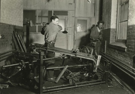 Lewis hine, Scrap metal junkies breaking up old looms, to be sold for scrap iron and said to be sent to Japan for munitions, Paterson, New Jersey, 1936   Gelatin silver print; printed c.1936   4 5/8 x 6 5/8 inches