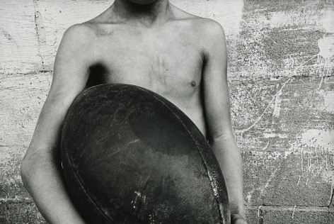 Mark Cohen, Boy and Football, 1974     Gelatin silver print; printed 2013  12 x 17 3/4 inches