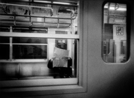 James Whitlow Delano, Mangaland, Absorbed in a newspaper, commuter train near Tokyo, Japan, 2009, Sous Les Etoiles Gallery