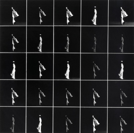Grid of 25 black and white  photo prints showing repeating images of two starkly lit navy sailors standing out against a black background.
