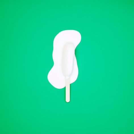 Color photo of a popsicle melting on a green background.