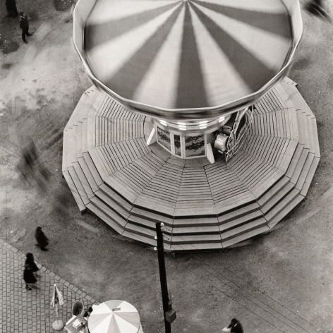 Black and white photo of a carnival ride carousel seen from above.