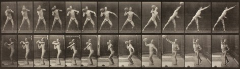 Series of black and white photos showing the movements of a man in a loin cloth heaving a large rock.