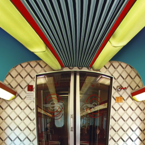 Color vertical panoramic photo of a train's dining car, with red and green decor.