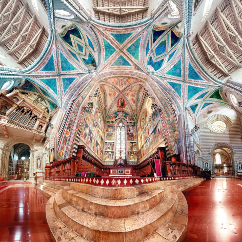 Panoramic composite color photo of the ornate interior of an Italian cathedral.