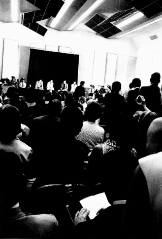 Black and white image from a Beatles press conference in 1966.&mdash;shot from the back of the room.