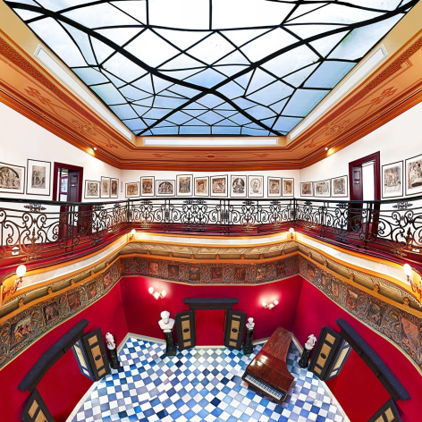 Distorted panoramic photo of an ornate music room with checkered floor, piano, and skylight.