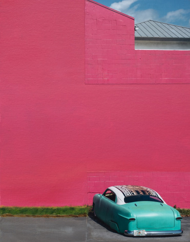 Collaged photograph of a bright turquoise classic car, painted in front of a painted pink wall.