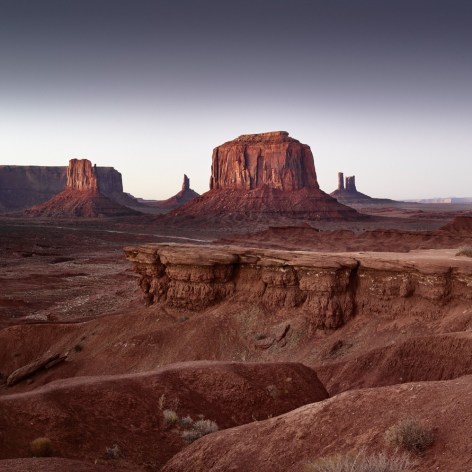 Color photograph of the Monument Valley buttes at dawn.