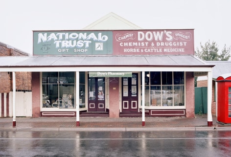 Color photo of old fashioend store fronts with signs for Dow's Pharmacy Museum