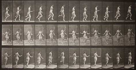 Sequential black and white photos of a topless woman skipping-rope