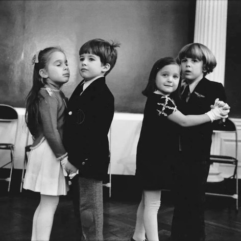 Black and white photo of four children, coupled up to take dance lessons