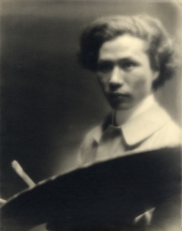 Gauzy black and white portrait of a Japanese American Artist, he is posed holding a painter's palette and a brush.