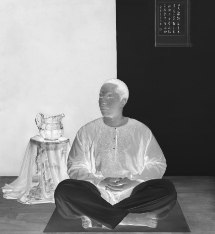 Black and white negative photographic image of woman with short hair sitting and mediating on a mat.
