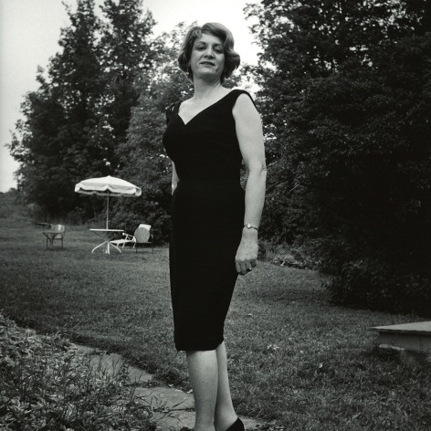 Black and white full body portrait of trans woman Susanna Valenti posing on the walk of her residence Casa Susanna.