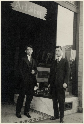 black and white photo of two Japanese American men in suits in front of their storefront&mdash;a sign reads &quot;Art Shop&quot;