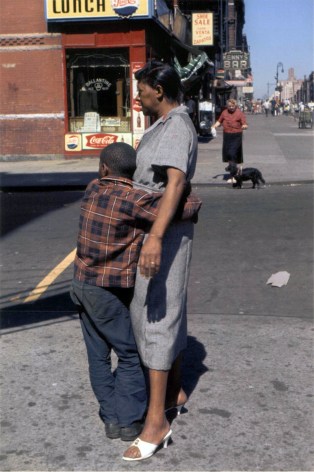 Color photograph of a young boy hugging his mother.