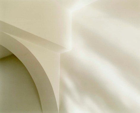 Color photo of light on a white painted interior archway.