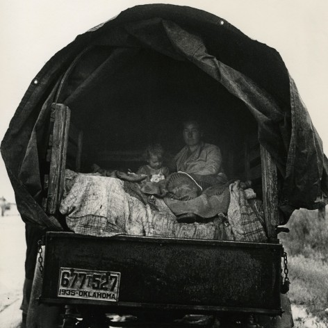 Mother and daughter Dust Bowl refugees living out of the back of a farm truck with Oklahoma license plates.