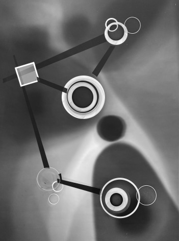 Black and white abstract photo print showing abstract composition made of brighter concentric circles and darker lines.