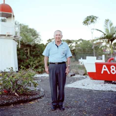 Employee of a maritime museum posing for his portrait with display outside