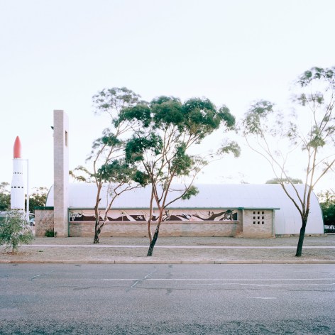 Exterior of a small regional museum with a rocket ship next to it