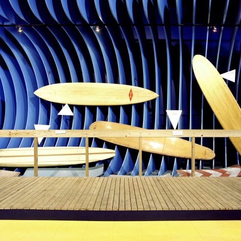 Color photo of surf boards in a museum display
