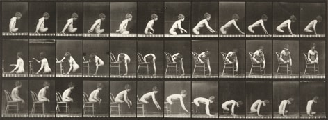 Sequence of black and white photos showing the movements of a boy with amputated legs getting of of a chair