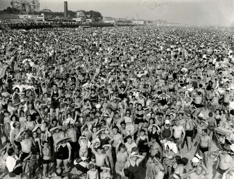 Black and white scene of a crowd&mdash;all facing the camera&mdash;at Coney Island in 1946